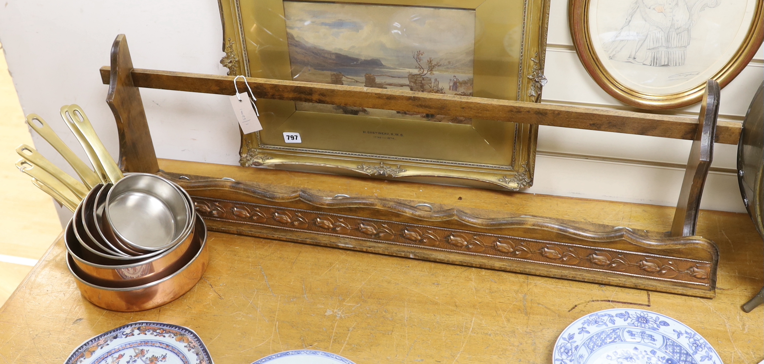 A graduated set of six copper and brass saucepans with beech hanging rack, 104cm wide